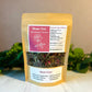 Beau-Tea packaging with tea leaves on a neutral background